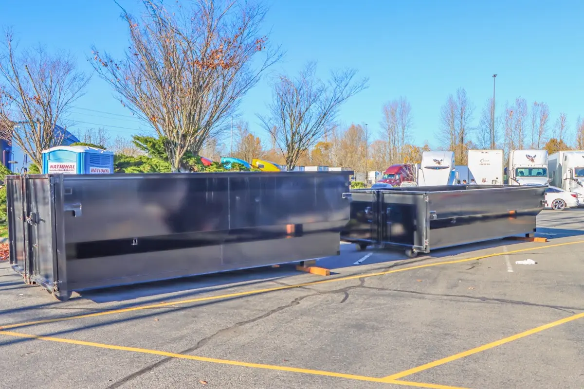 Professional dumpster rental service with roll-off container on residential driveway in Batavia